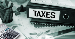 A calculator and tax forms, representing tax planning and optimization.